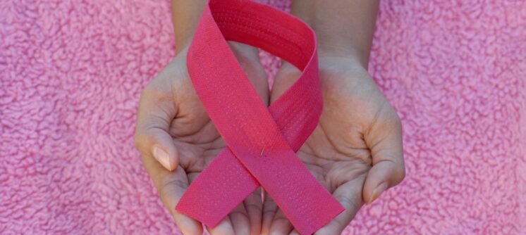 person with pink band on her left hand